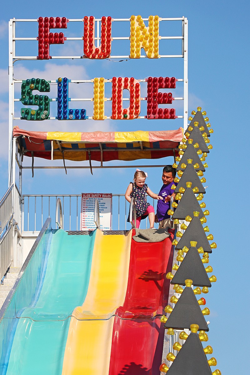 Greta Cross / News Tribune
Madison Bolin, 5, prepares to ride down the Fun Slide carnival ride at the Jefferson City Jaycees Cole County Fair Thursday night.