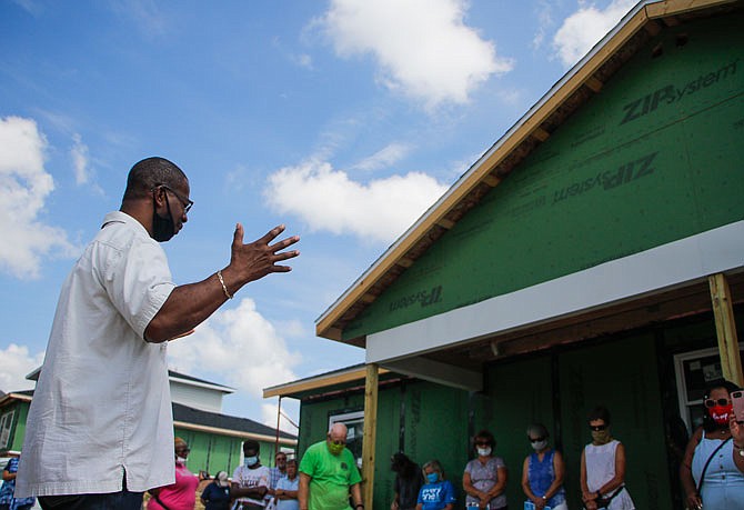 Pastor Gregory Reeves, of the Jefferson City Church of God in Christ, says a prayer Saturday at Habitat for Humanity's Blessing of the Build on Ashley Street.
