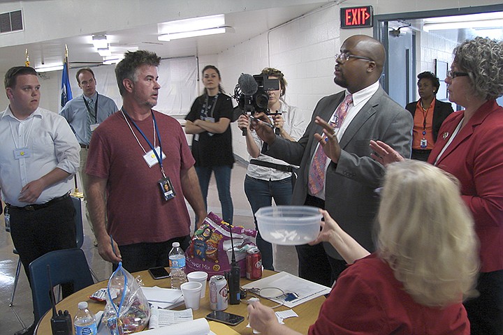 In this April 27, 2017, file photo, Solomon Graves, right, explains to members of the media the ground rules for selecting media witnesses for the scheduled execution of Kenneth Williams at the Cummins Unit prison at Varner, Ark. Arkansas Gov. Asa Hutchinson on Thursday, July 23, 2020, named Graves, a former spokesman for the state's prisons and the Department of Correction's chief of staff as the new head of the prison and parole system. (AP Photo/Kelly P. Kissel, File)