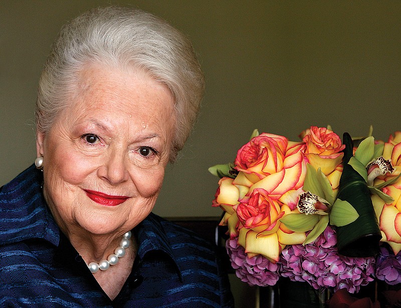 Actress Olivia de Havilland, who played the doomed Southern belle Melanie in "Gone With the Wind," poses for a 2004 photograph, in Los Angeles. The Oscar-winning actress died Sunday in Paris at age 104.