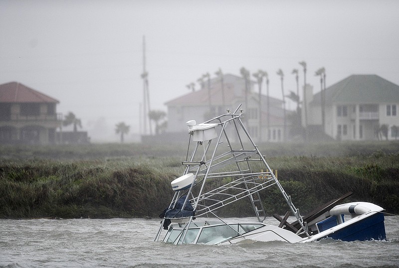 A boat sinks Saturday in the Packery Channel during Hurricane Hanna in North Padre Island, Texas. The Category 1 storm continued to strengthen before reaching Padre Island at 5 p.m. Saturday, July 25, 2020.