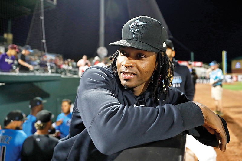 In this March 6 file photo, Marlins pitcher Jose Urena leans on railing in the dugout prior to a spring training game against the Nationals in Jupiter, Fla.