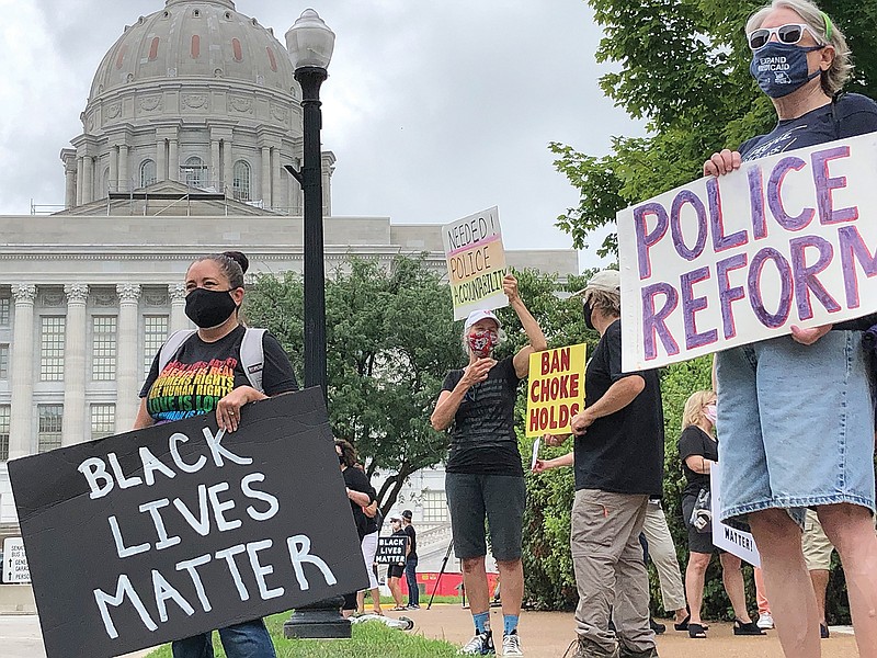 From left, Vani Rumford, Nancy Ames, Scott Randolph and Sue Gibson, members of the Jefferson City Racial Equity Group, rally Monday outside the Capitol. They called on legislators to take measures to prevent crimes, rather than increase punishments afterward.