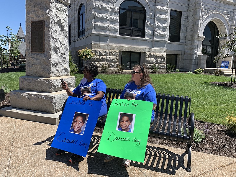 Mary Williams Coley, left, and Kathy Mueller sat in front of the Cole County Courthouse on Tuesday, July 28, to draw attention to the 2018 death of Darnell Gray. The women used Facebook Live video to broadcast their message.