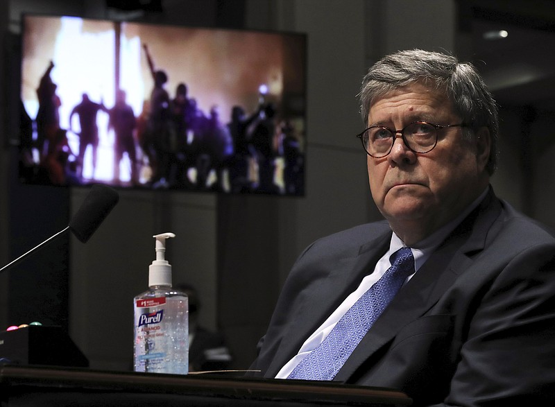 Attorney General William Barr listens during a House Judiciary Committee hearing on the oversight of the Department of Justice as a video plays in the background on Capitol Hill, Tuesday, July 28, 2020 in Washington. (Chip Somodevilla/Pool via AP)