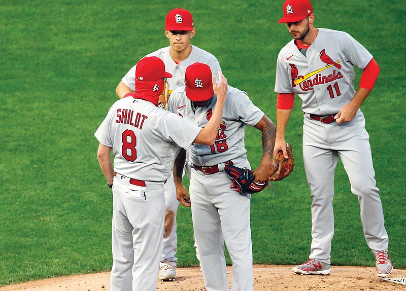 Cardinals manager Mike Shildt consoles pitcher Carlos Martinez as he pulls him following a solo home run by the Twins' Josh Donaldson in the fourth inning of Tuesday's game in Minneapolis.