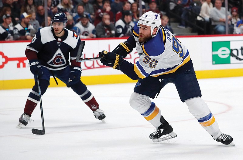 In this Jan. 18 file photo, Blues center Ryan O'Reilly fires a shot at the net as Colorado Avalanche left wing Matt Nieto defends during the second period of a game in Denver. 