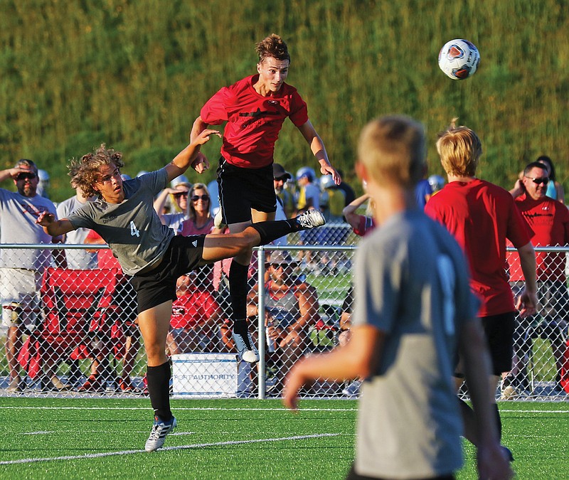 Quinn Walker of the Jays heads the ball next to Capital City's Mohaned Yanis on Tuesday during a friendly soccer game at Capital City High School.