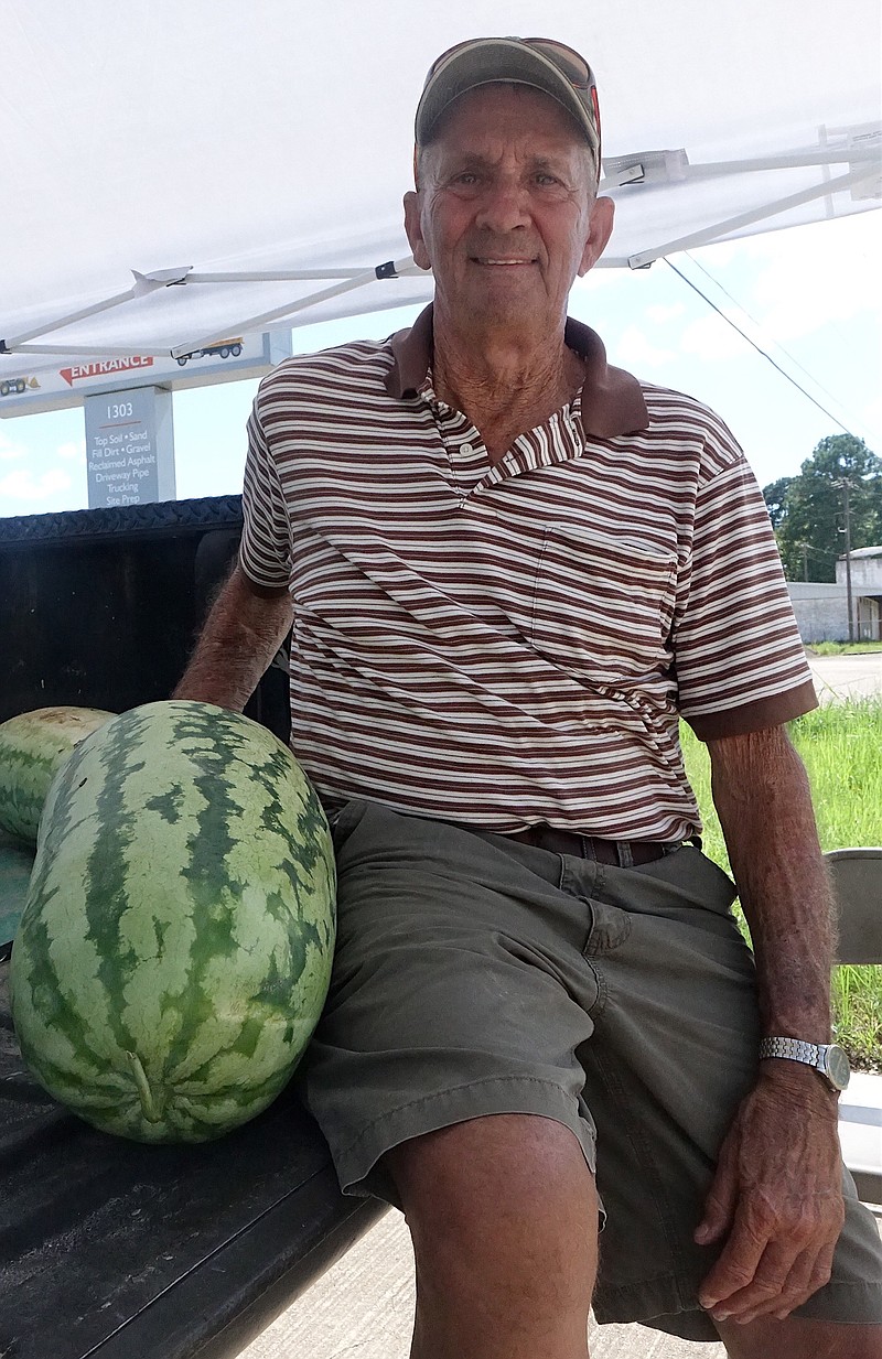 Kenneth Pate sits underneath a white tent to sell watermelons along U.S. Highway 59 in Atlanta, Texas. The former Cass County commissioner for Precinct 1 says lots of friends and people he knows pass by.
