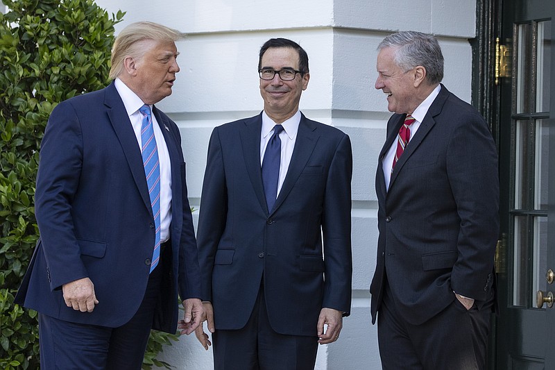 President Donald Trump, Treasury Secretary Steven Mnuchin, White House Chief of Staff Mark Meadows talk before Trump speaks with reporters on the South Lawn of the White House, Wednesday, July 29, 2020, in Washington. Trump is en route to Texas. (AP Photo/Alex Brandon)