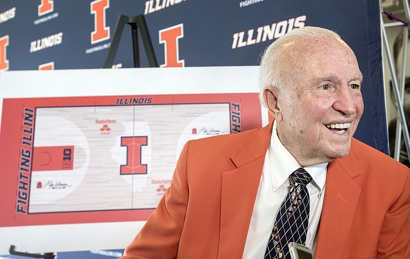 In this Aug. 24, 2015, file photo, former Illinois men's basketball coach Lou Henson is interviewed during a ceremony announcing the naming of the basketball court at State Farm Center to "Lou Henson Court" at Memorial Stadium's 77 Club in Champaign, Ill.