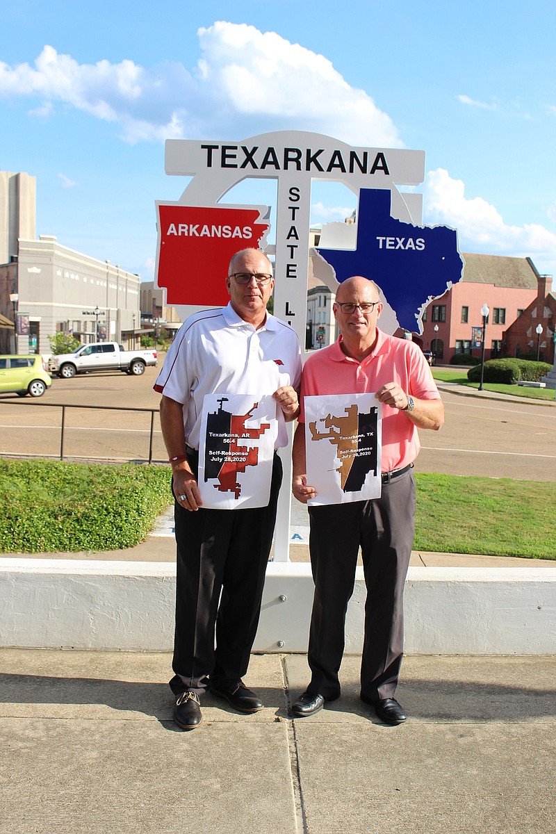 Texarkana, Arkansas, Mayor Allen Brown, left, and Texarkana, Texas, Mayor Bob Bruggeman pose for a photo Tuesday in front of the federal courthouse and post office on the state line downtown. The mayors announced a Census response challenge. The mayor of the Texarkana with the lower Census response rate in August will wear clothes representing the other's state for a week.