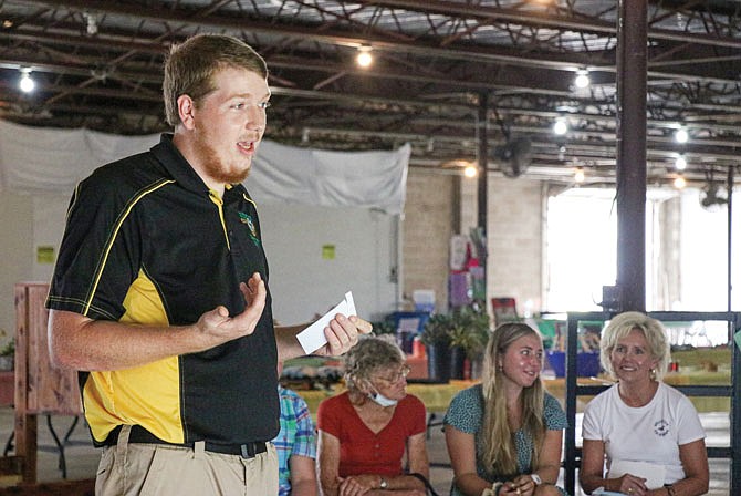 Taylor Riley presents his extemporaneous speech Thursday during the 4-H public speaking contest in the 4-H exhibition hall. In the extemporaneous category, members have only 15 minutes to choose a prompt from a list of three and prepare their speech before speaking in front of the judges. Riley chose the prompt, "How have I helped 4-H youth?" He spoke about his experiences as a youth leader for small ruminants, 4-H Camp counselor and state and national shooting sports ambassador. Riley placed second in his category and received a blue ribbon.