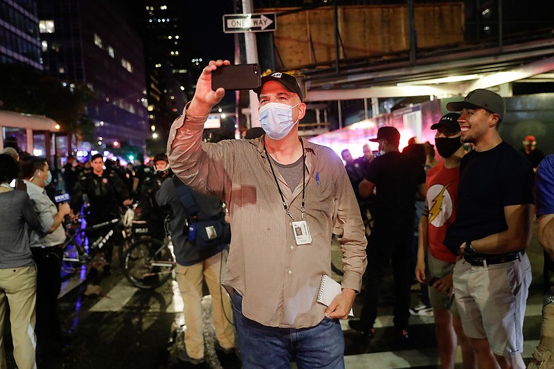 Associated Press NBA reporter Brian Mahoney records video while covering a protest, Wednesday, June 3, 2020, in New York. When the NBA season was suspended and he was reassigned to the news department, he assumed it was just to report from here. But, according to Mahoney, there were so many coronavirus stories to tell: Health care workers trying to keep patients alive. Residents of a community who all knew somebody who had died.   (AP Photo/Seth Wenig)