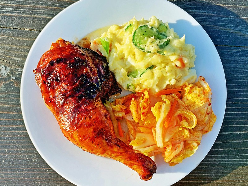 Gochujang-glazed grilled chicken with potato salad and kimchi. (Genevieve Ko/Los Angeles Times/TNS)