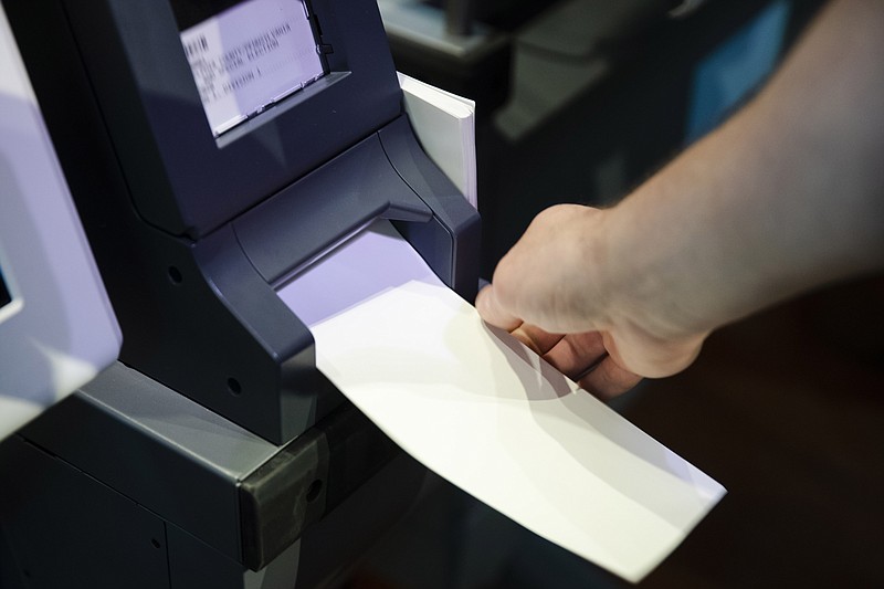 FILE—In this June 13, 2019 file photo, an Investigator with the Office of the City Commissioners, demonstrates the ExpressVote XL voting machine at the Reading Terminal Market in Philadelphia.   As the Nov. 3 2020 presidential vote nears, there are fresh signs that the nation’s electoral system is again under attack from foreign adversaries.Intelligence officials confirmed in recent days that foreign actors are actively seeking to compromise the private communications of “U.S. political campaigns, candidates and other political targets” while working to compromise the nation's election infrastructure.  (AP Photo/Matt Rourke, File)