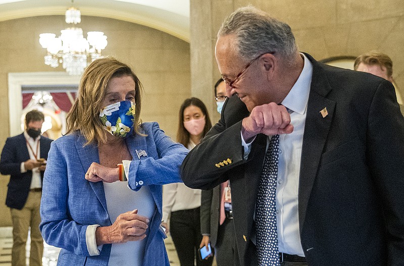 House Speaker Nancy Pelosi of Calif., gives Senate Minority Leader Chuck Schumer of N.Y., an elbow bump as Schumer leaves following a meeting at the Capitol with White House chief of staff Mark Meadows and Treasury Secretary Steven Mnuchin on a COVID-19 relief bill, Saturday, Aug. 1, 2020, in Washington. (AP Photo/Manuel Balce Ceneta)