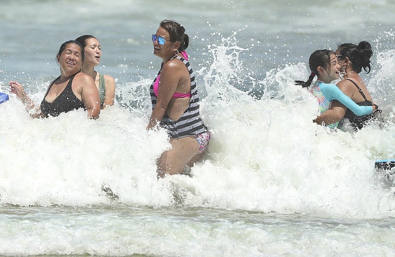 Daytona Beach, Fla., is crowded with beachgoers Saturday, Aug. 1, 2020. Isaias is expected to return to hurricane strength as it nears Florida. (Stephen M. Dowell/Orlando Sentinel via AP)