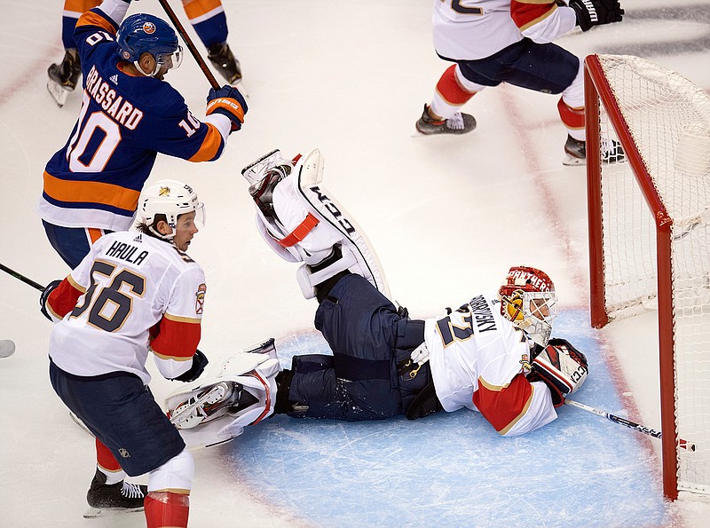 New York Islanders centre Derick Brassard (10) and Florida Panthers left wing Erik Haula (56) chase as Panthers goaltender Sergei Bobrovsky (72) sprawls during second-period NHL hockey game action in Toronto, Saturday, Aug. 1, 2020. (Frank Gunn/The Canadian Press via AP)