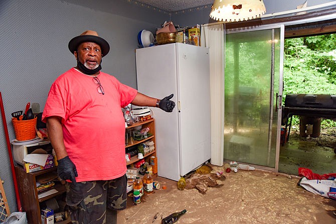 Aug. 2, 2020, photo: Residents of houses and bottom floor apartments on Christopher Place on the city's east side, including Earnette Smith shown here, are still cleaning up from flash flooding July 19. 