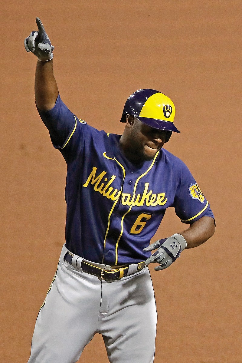 Lorenzo Cain of the Brewers celebrates at first base after driving in a run with a single during last Monday's game against the Pirates in Pittsburgh.