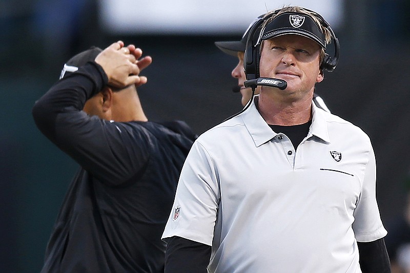 In this Dec. 8, 2019, file photo, Raiders coach Jon Gruden walks on the sideline during the second half of a game against the Titans in Oakland, Calif. 