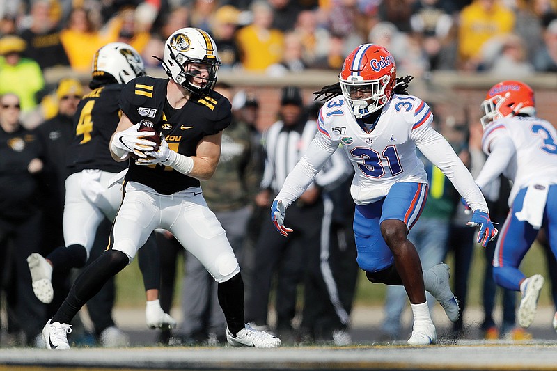 Missouri wide receiver Barrett Banister catches a pass as Florida defensive back Shawn Davis defends during an SEC game last season at Faurot Field.