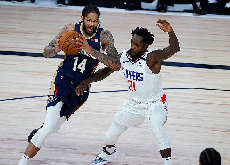 New Orleans Pelicans' Brandon Ingram, left, drives past Los Angeles Clippers' Patrick Beverley during an NBA basketball game Saturday, Aug. 1, 2020, in Lake Buena Vista, Fla. (Kevin C. Cox/Pool Photo via AP)