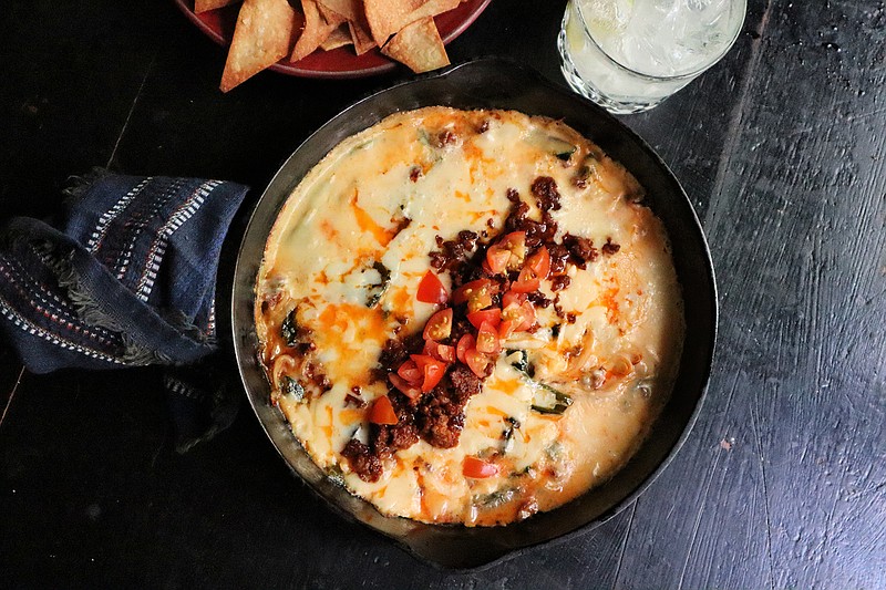 Queso fundido with chorizo and roasted poblano peppers is a satisfying, cheesy appetizer. (Gretchen McKay/Pittsburgh Post-Gazette/TNS)
