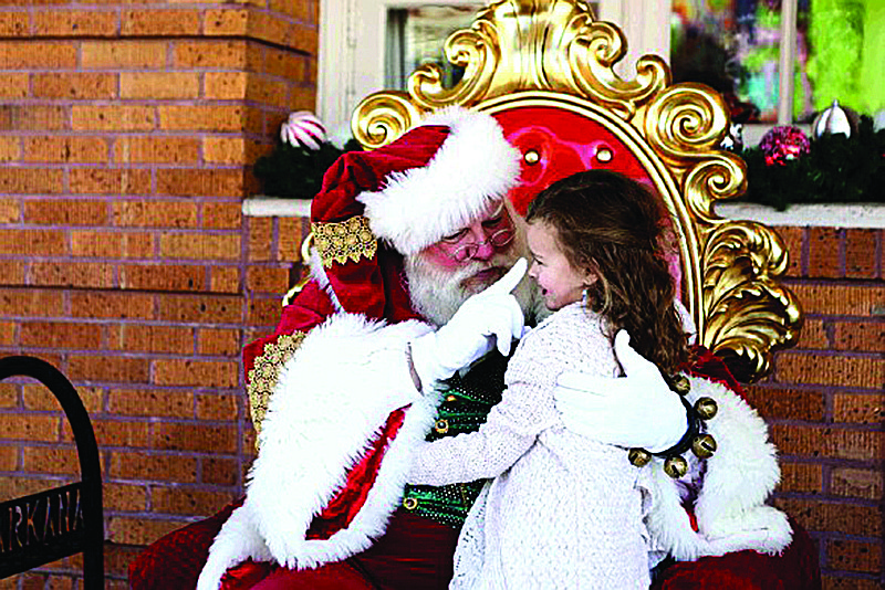 Adaleigh Lummus, sits on Santa Claus' lap in front of the Perot Theatre during TRAHC's first Holiday Traditions event in 2018. TRAHC plans to continue the annual holiday festivities this year. 
