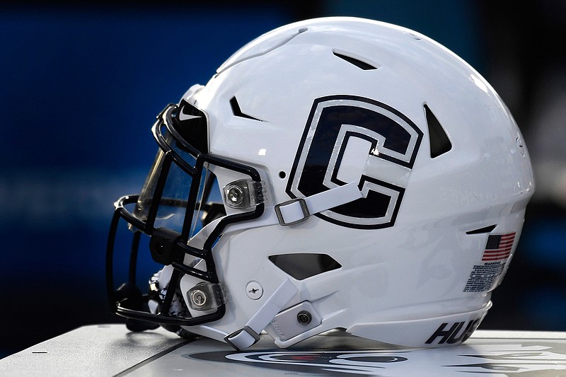 In this Sept. 7, 2019, file photo, Connecticut football helmet rests on the sideline during an NCAA college football game in East Hartford, Conn. UConn has canceled its 2020-2021 football season, becoming the first FBS program to suspend football because of the coronavirus pandemic.(AP Photo/Jessica Hill, File)
