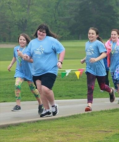 <p>Elizabeth and her team cross the finish line together at the end-of-season 5K.</p>