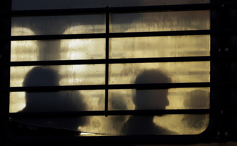 FILE - In this Nov. 16, 2018, file photo, immigrants who entered the United States illegally wait to board a plane for a deportation flight. More than 2,000 unaccompanied children have been expelled since March under an emergency declaration enacted by the Trump administration, which has cited the coronavirus in refusing to provide them protections under federal anti-trafficking and asylum laws. (AP Photo/David J. Phillip, File)