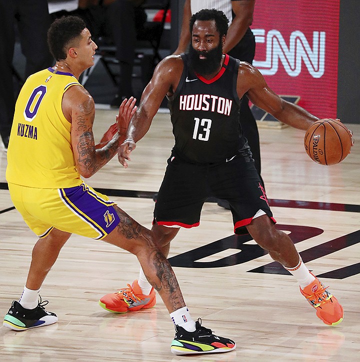 Houston Rockets guard James Harden (13) dribbles while defended by Los Angeles Lakers forward Kyle Kuzma (0) during the second half of an NBA basketball game Thursday, Aug. 6, 2020, in Lake Buena Vista, Fla. (Kim Klement/Pool Photo via AP)