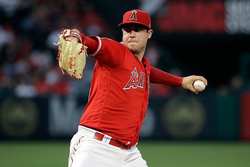 In this June 29, 2019, file photo, Los Angeles Angels starting pitcher Tyler Skaggs throws to the Oakland Athletics during a baseball game in Anaheim, Calif. Federal prosecutors say a former Angels employee has been charged with conspiracy to distribute fentanyl in connection with last year's overdose death of Angels pitcher Tyler Skaggs. Prosecutors in Texas say Eric Prescott Kay was arrested in Fort Worth, Texas, and made his first appearance Friday, Aug. 7, 2020, in federal court. Kay was communications director for the Angels. (AP Photo/Marcio Jose Sanchez, File)