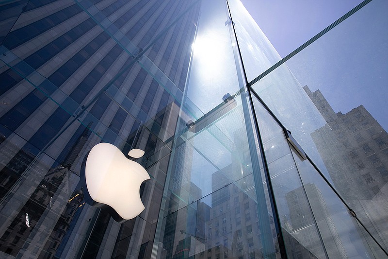  In this Tuesday, June 16, 2020 file photo, the sun is reflected on Apple's Fifth Avenue store in New York.  Apple has managed to shine amid the gloom, putting it on the cusp of becoming the first U.S. company to boast a market value of $2 trillion, just two years after it became the first to reach $1 trillion. With its stock already up 50% this year, the only question among analysts is whether Apple will pass the $2 trillion milestone before the release of its next-generation iPhones in October.(AP Photo/Mark Lennihan, File)