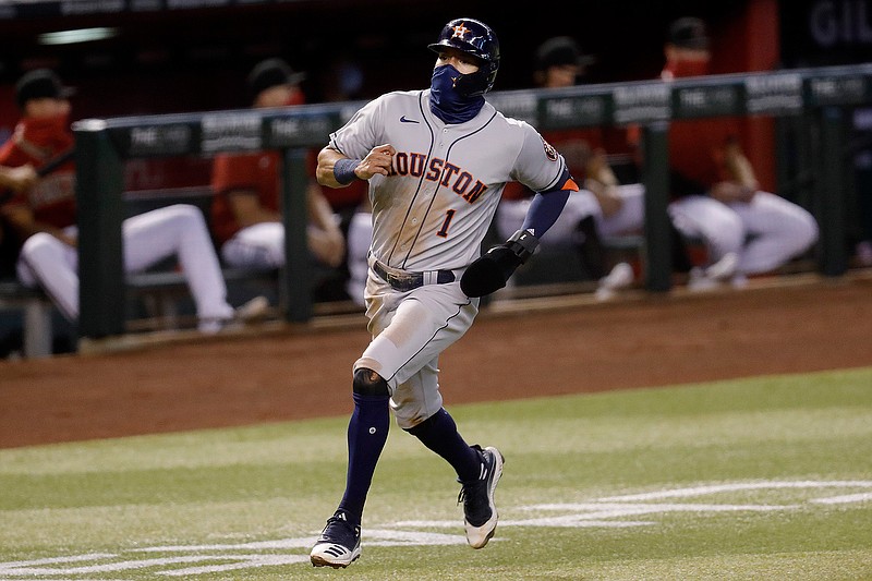 Houston Astros' Carlos Correa (1) scores on a base hit by teammate Abraham Toro during the second inning of a baseball game against the Arizona Diamondbacks Wednesday, Aug. 5, 2020, in Phoenix. (AP Photo/Matt York)