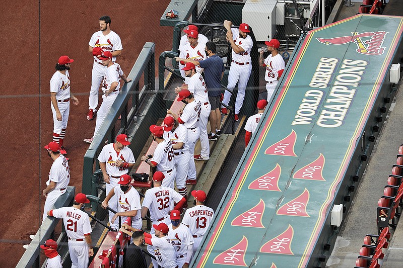 Members of the St. Louis Cardinals wait to be introduced before the start of a game against the Pittsburgh Pirates last month at Busch Stadium.