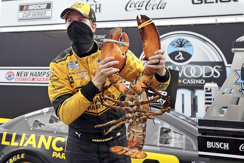 Brad Keselowski holds a giant lobster to celebrate his victory in a NASCAR Cup Series race Sunday at the New Hampshire Motor Speedway in Loudon, N.H.