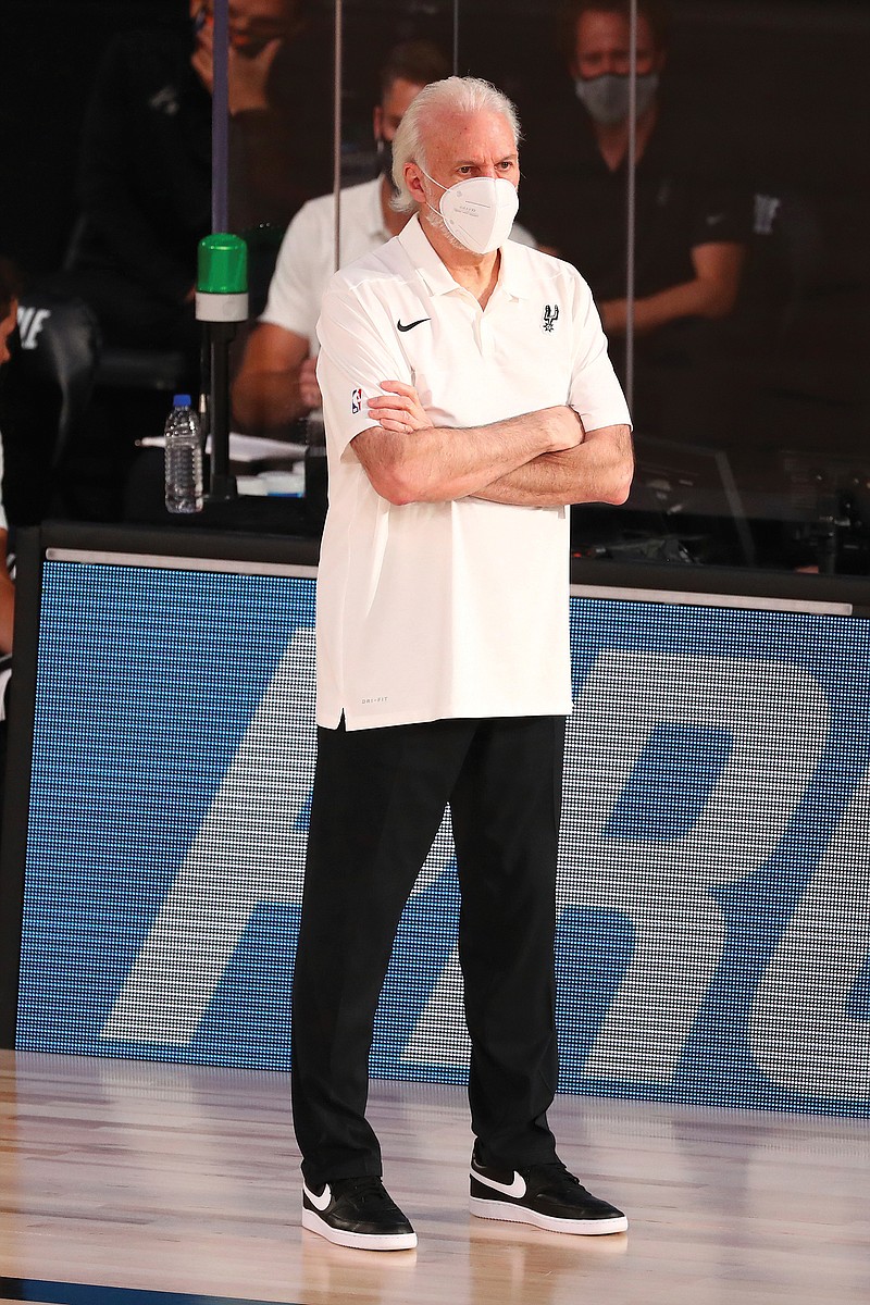 Spurs head coach Gregg Popovich wears a mask while looking on during the first half of Wednesday's game against the Nuggets in Lake Buena Vista, Fla.