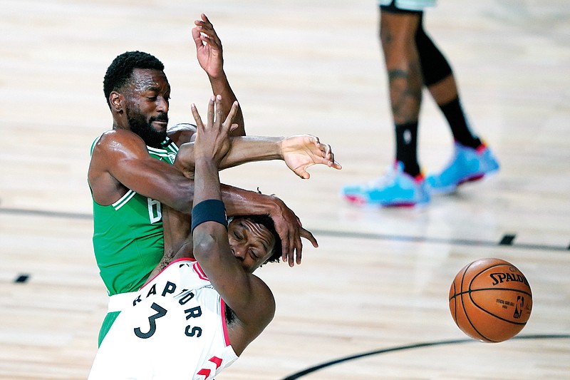 OG Anunoby of the Raptors and Kemba Walker of the Ceitics collide while competing for possession during the first half Friday's game in Lake Buena Vista, Fla. Anunoby had three points and two rebounds in Toronto's 122-100 loss to Boston.