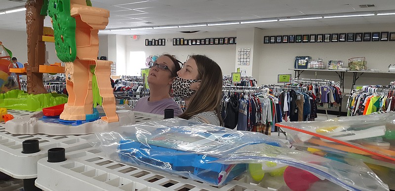 Customers contemplate the goods for children at Polka Dots and Lollipops, an upscale consignment sale for children. Saturday is the last day of their fall-winter back-to-school sale. 