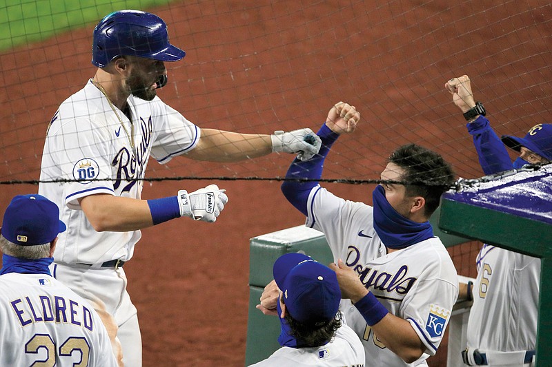 Ryan McBroom is greeted at the dugout by his Royals teammates after his solo home run in the sixth inning of Friday night's game against the Twins at Kauffman Stadium.