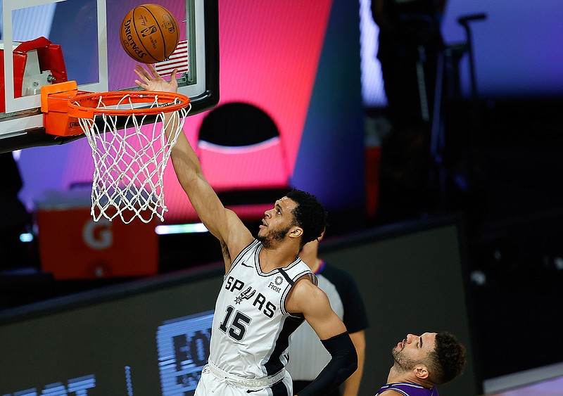 San Antonio Spurs' Quinndary Weatherspoon (15) goes to the basket past Utah Jazz' Georges Niang during the second half of an NBA basketball game Friday, Aug. 7, 2020, in Lake Buena Vista, Fla. (Kevin C. Cox/Pool Photo via AP)