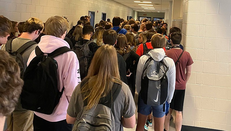 In this photo posted on Twitter, students crowd a hallway, Tuesday, Aug. 4, 2020, at North Paulding High School in Dallas, Ga.  The Georgia high school student says she has been suspended for five days because of photos of crowded conditions that she provided to The Associated Press and other news organizations. Hannah Watters, a 15-year-old sophomore at North Paulding High School, says she and her family view the suspension as overly harsh and are appealing it. (Twitter via AP, File)