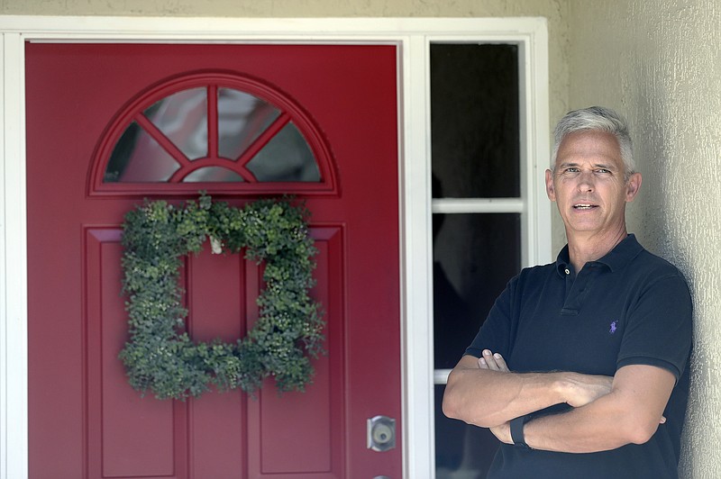 Bob Garick stands by the entrance to his home Wednesday, Aug. 5, 2020, in Oviedo, Fla. Garick was looking forward to being a field supervisor during the door-knocking phase of the 2020 census, but as the number of new coronavirus cases in Florida shot up last month, he changed his mind and decided not to take the job. (AP Photo/John Raoux)