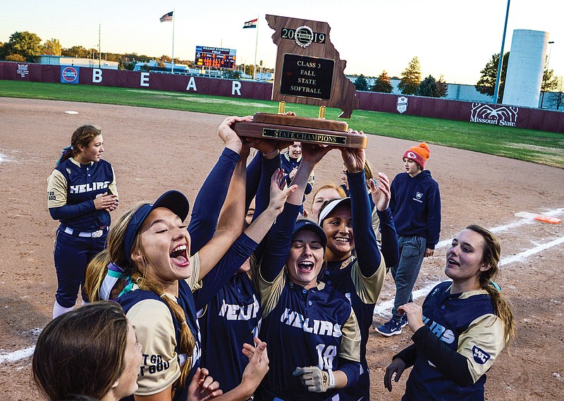 Players from the Helias softball team hoist the 2019 Class 3 first-place trophy after winning the state championship game against Sullivan at Killian Softball Complex in Springfield. Under the new MSHSAA championship factor, the Lady Crusaders softball team will move up one class during the 2020 season.