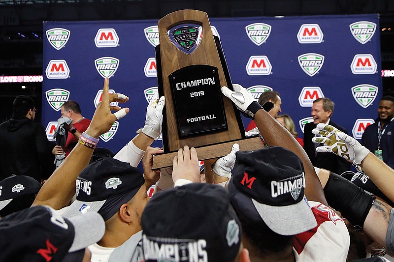 In this Dec. 7, 2019, file photo, members of the Miami (Ohio) team hold the trophy after beating Central Michigan in the Mid-American Conference title game in Detroit.