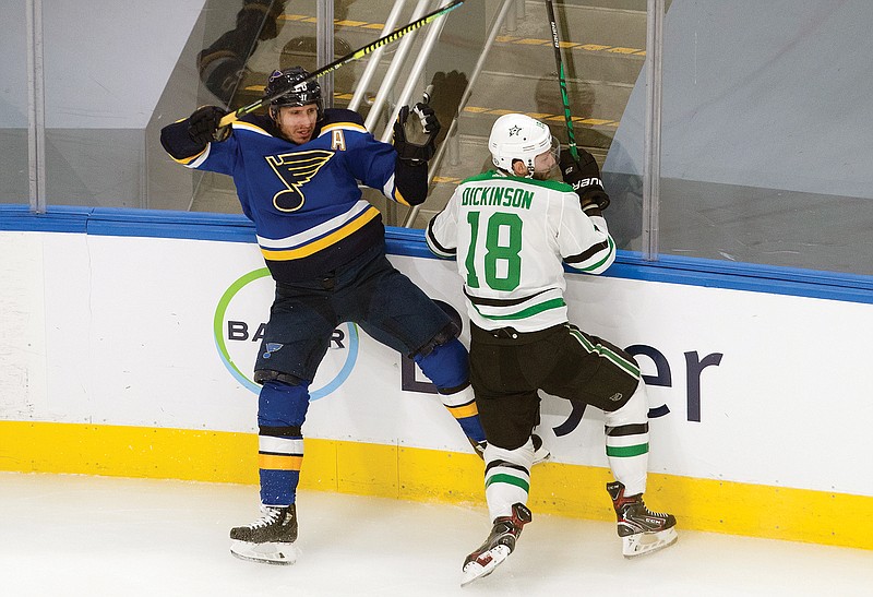 Alexander Steen of the Blues is checked by Jason Dickinson of the Stars during the second period of Sunday afternoon's game in Edmonton, Alberta.