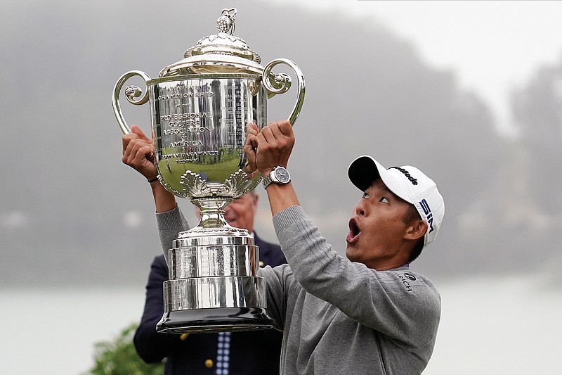 Collin Morikawa reacts as the top of the Wanamaker Trophy starts to fall during Sunday's presentation after winning the PGA Championship at TPC Harding Park in San Francisco.